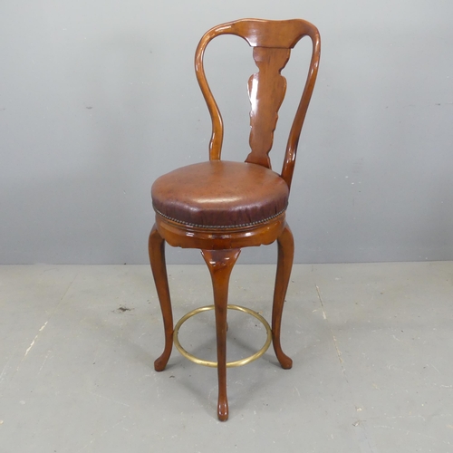 2738 - A mahogany and studded faux leather upholstered swivel bar stool in the Georgian style, with brass f... 