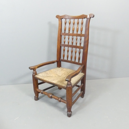 2761 - A 19th century ash and elm Lancashire rush-seated spindle-back nursing chair.