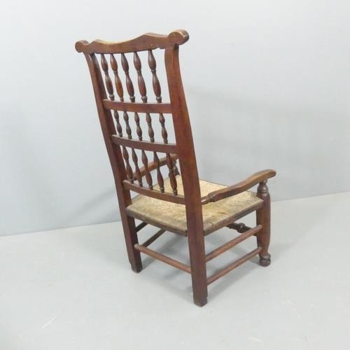 2761 - A 19th century ash and elm Lancashire rush-seated spindle-back nursing chair.