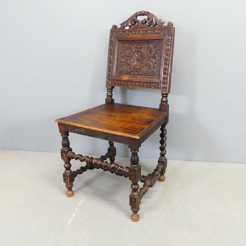 2752 - A 17th century style oak chair, with carved decoration and barley twist supports.