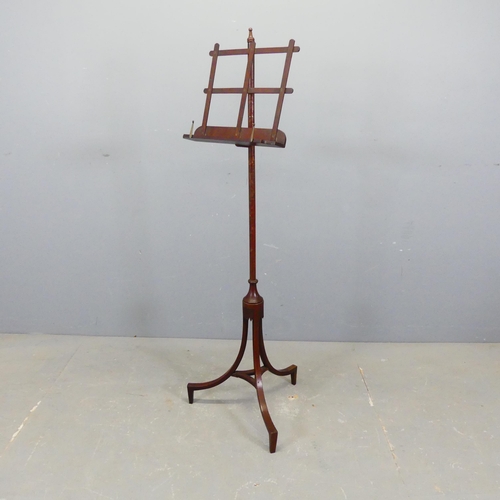 2753 - An Edwardian mahogany music stand, with adjustable height and tripod base. Height as pictured 128cm.