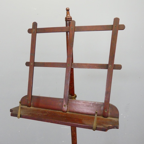 2753 - An Edwardian mahogany music stand, with adjustable height and tripod base. Height as pictured 128cm.