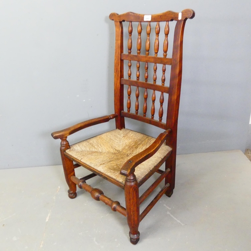 2761 - A 19th century ash and elm Lancashire rush-seated spindle-back nursing chair.