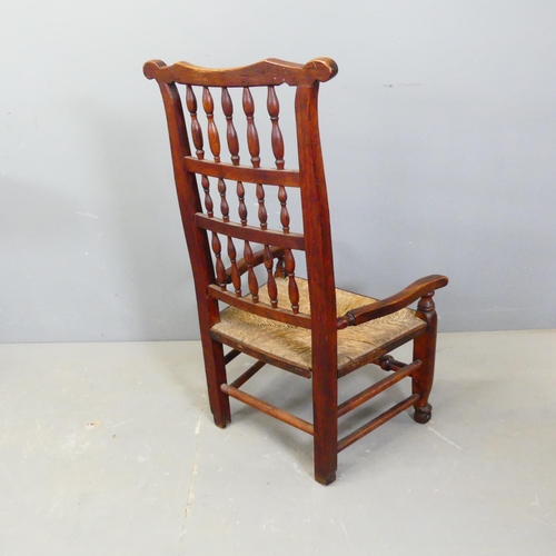 2761 - A 19th century ash and elm Lancashire rush-seated spindle-back nursing chair.