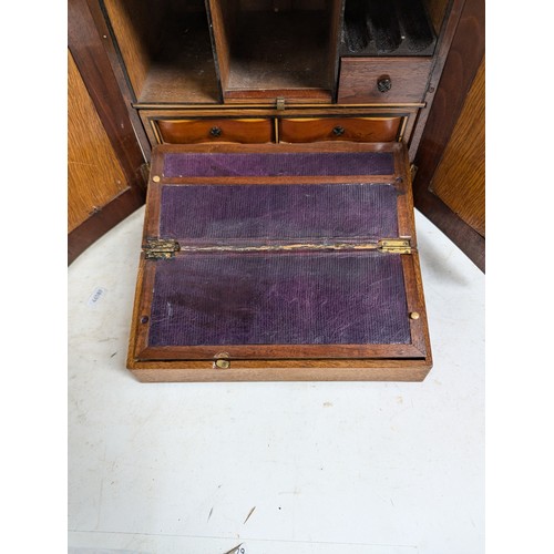 5 - A 19th century apprentice-piece table-top writing cabinet, the hinged doors with brass grills openin... 