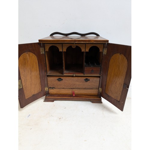 5 - A 19th century apprentice-piece table-top writing cabinet, the hinged doors with brass grills openin... 