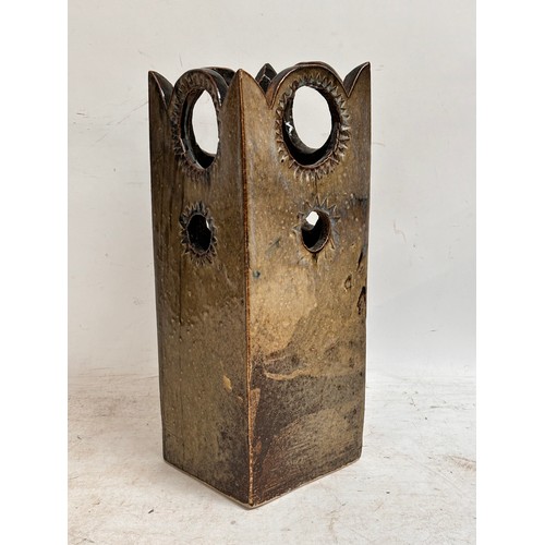 908 - A glazed studio pottery umbrella stand, with crown style decorative finish. Various pierced sections... 