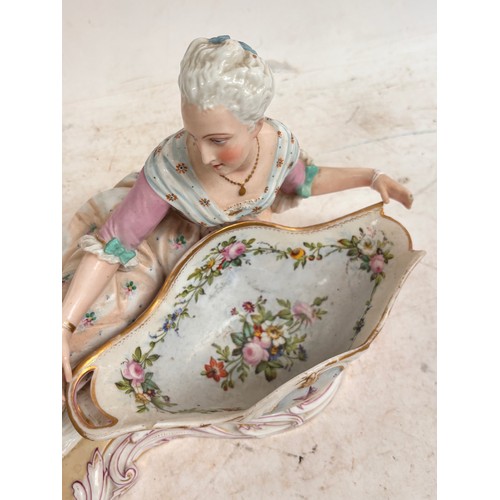 21 - MEISSEN - a large 19th century porcelain sweetmeat basket, modelled as a lady lying beside a basket ... 