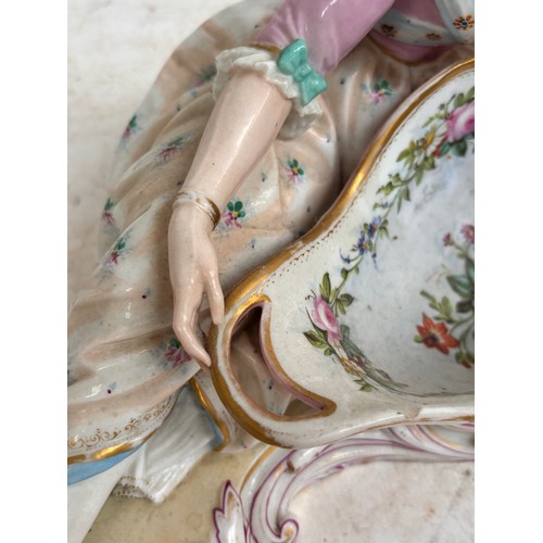 21 - MEISSEN - a large 19th century porcelain sweetmeat basket, modelled as a lady lying beside a basket ... 