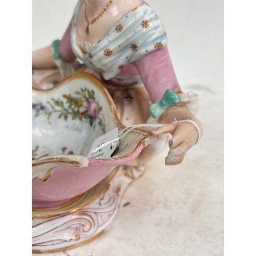 21 - MEISSEN - a large 19th century porcelain sweetmeat basket, modelled as a lady lying beside a basket ... 