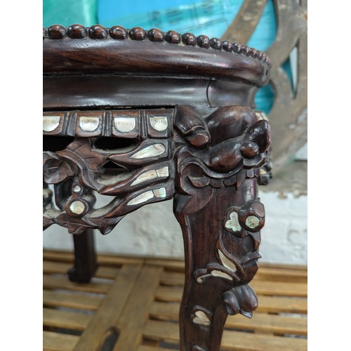 2737 - A Chinese hardwood marble topped jardinière / plant stand, with mother of pearl in lay, carved and p... 