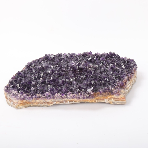 106 - A flat amethyst geode slice, 6.7kg, 30cm x 27cm