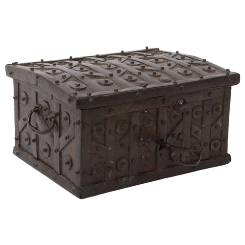 113 - An Antique iron-bound oak casket, probably 17th/18th century, with allover disc bosses, iron carryin... 