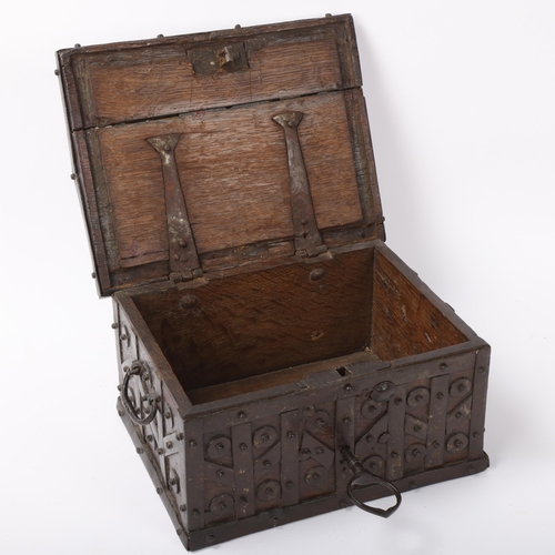 113 - An Antique iron-bound oak casket, probably 17th/18th century, with allover disc bosses, iron carryin... 