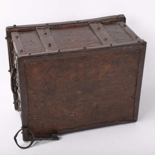 113 - An Antique iron-bound oak casket, probably 17th/18th century, with allover disc bosses, iron carryin... 