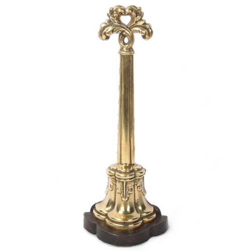 144 - Victorian brass and cast-iron doorstop, with acanthus handle, height 39cm