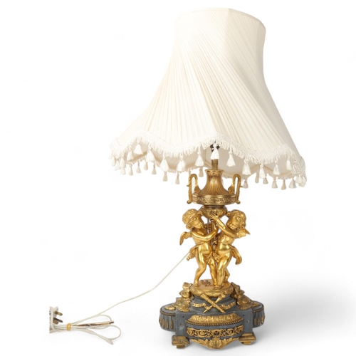 169 - An ornate French gilt-bronze table lamp, supported by 2 cherubs, probably late 19th century, on ormo... 