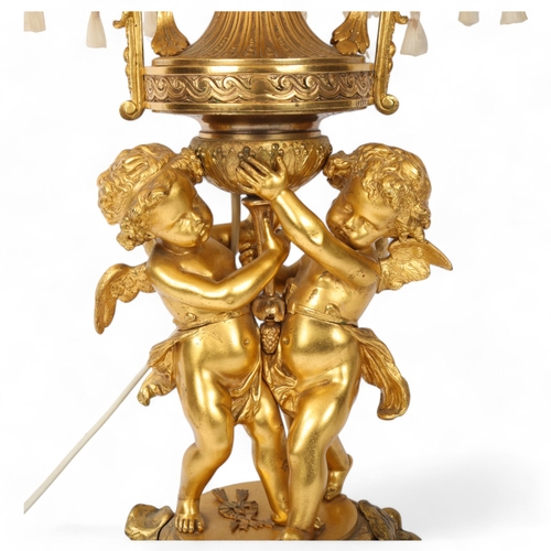 169 - An ornate French gilt-bronze table lamp, supported by 2 cherubs, probably late 19th century, on ormo... 