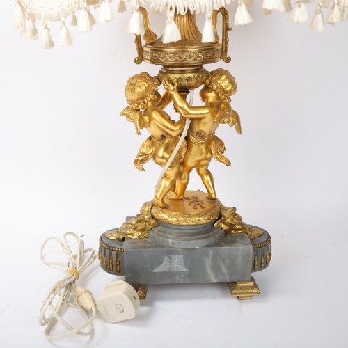 169 - An ornate French gilt-bronze table lamp, supported by 2 cherubs, probably late 19th century, on ormo... 