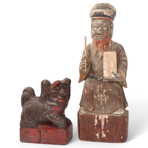 185 - A Chinese carved and painted wood figure of a sage, height 41cm, and a carved wood dog of fo, height... 