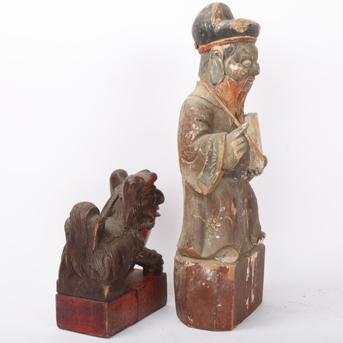 185 - A Chinese carved and painted wood figure of a sage, height 41cm, and a carved wood dog of fo, height... 