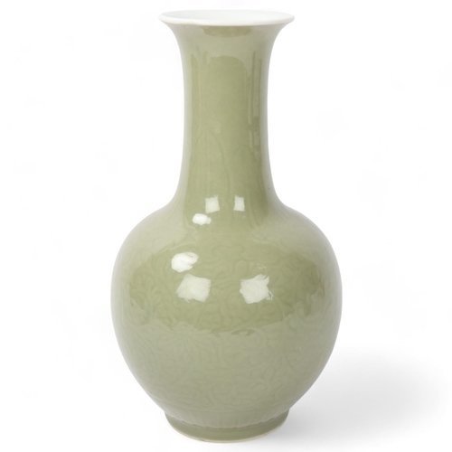 192 - A Chinese celadon glaze porcelain baluster vase, with incised decoration, height 30cm, drilled