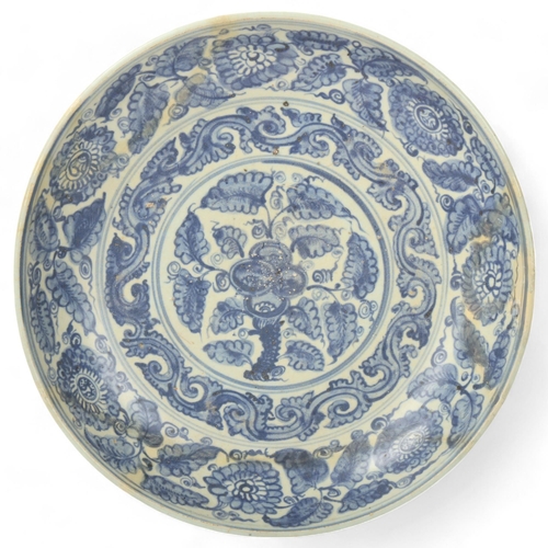 194 - A Chinese blue and white porcelain bowl, with painted leaf decoration, diameter 32cm, restored