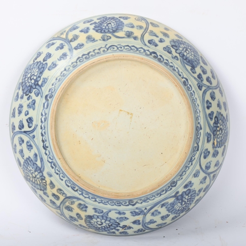 194 - A Chinese blue and white porcelain bowl, with painted leaf decoration, diameter 32cm, restored