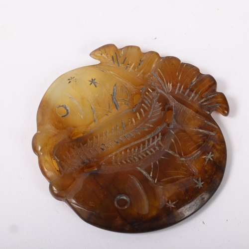 215 - A Chinese relief carved and pierced fish design pendant, length 5.5cm