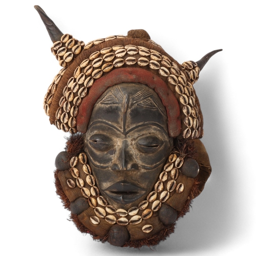 221 - African Dan headdress, carved wood with shell mounts, Ivory Coast, height approx 38cm