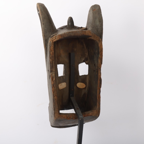 226 - Bamana (West Africa) carved wood Tribal mask, on metal stand, overall height 58cm