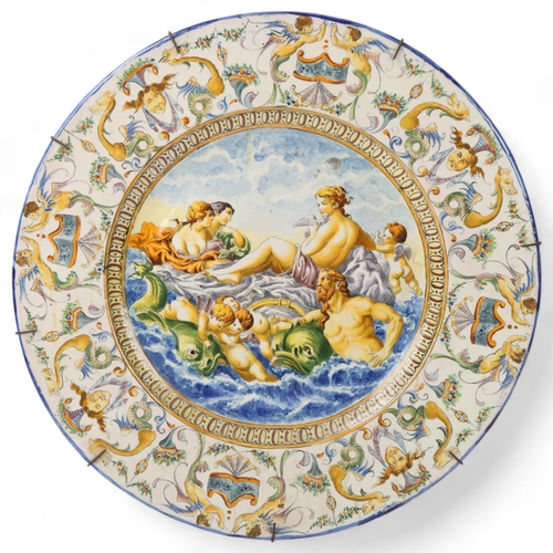 239 - A large 19th century Italian faience pottery charger, with painted Classical scenes, diameter 49cm