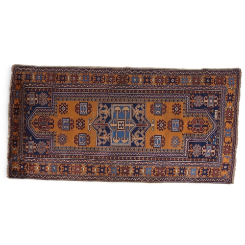 285 - A Caucasian blue and yellow ground wool rug, 224cm x 124cm