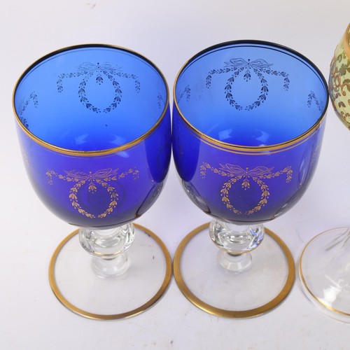 247 - A pair of gilded Bristol blue glass rummers, height 16.5cm, and a pair of Bohemian gilded amber glas... 