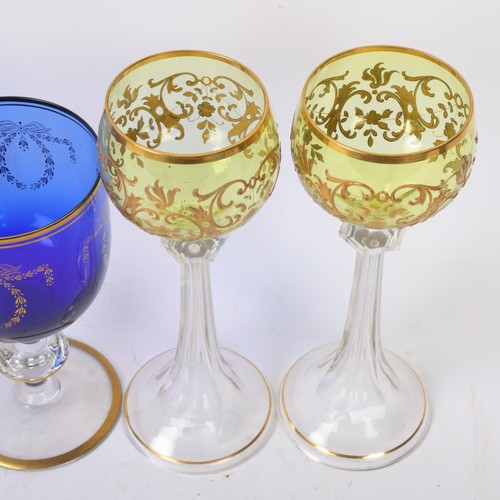 247 - A pair of gilded Bristol blue glass rummers, height 16.5cm, and a pair of Bohemian gilded amber glas... 