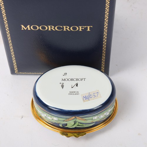 249 - MOORCROFT - an enamel box, lily of the valley design, length 6.5cm, boxed