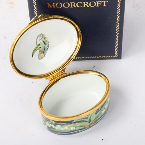 249 - MOORCROFT - an enamel box, lily of the valley design, length 6.5cm, boxed