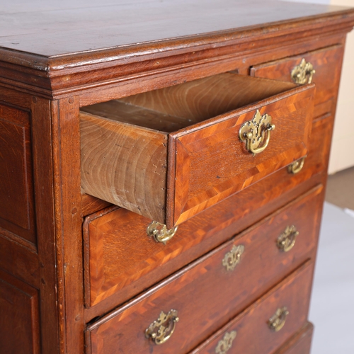 173 - An 18th century oak chest of drawers, with walnut feather banded drawer fronts panelled sides and br... 