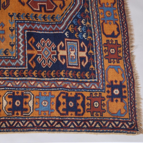 285 - A Caucasian blue and yellow ground wool rug, 224cm x 124cm