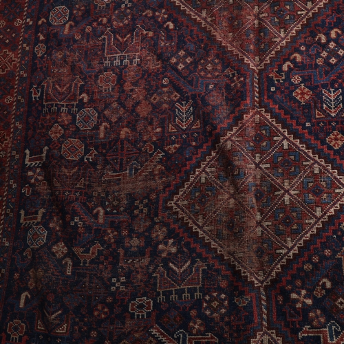 286 - An Antique Persian Beluchi wool rug, with bird and lozenge decoration, 190cm x 165cm