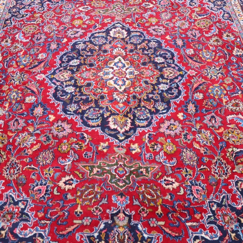 292 - A large Middle Eastern Kashan red ground wool rug, 383cm x 294cm