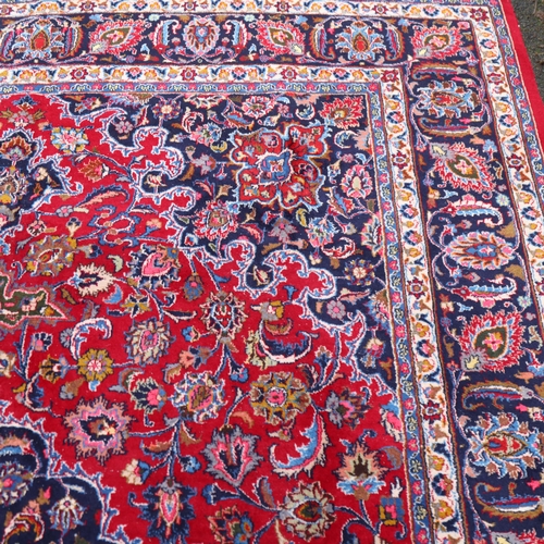 292 - A large Middle Eastern Kashan red ground wool rug, 383cm x 294cm