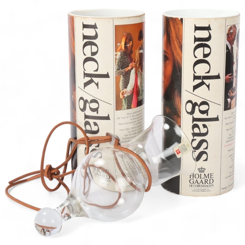 411 - A pair of mid 20th century Holmegaard neck glasses, with leather lanyard, original boxes and labels