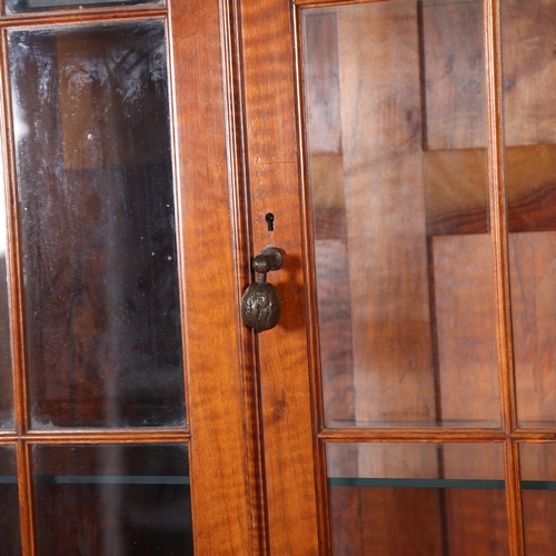 437 - A Cotswold School English walnut and glazed display cabinet on fine barley twist legs with a cast br... 