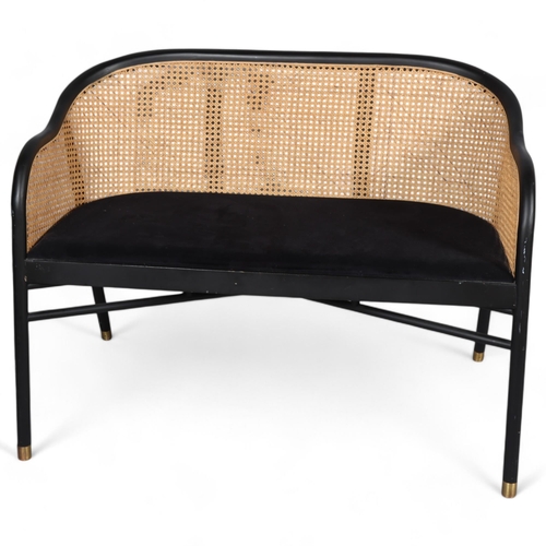 453 - An ebonised bentwood sofa, with caned back and brass feet, in the manner of Thonet,  L103cm