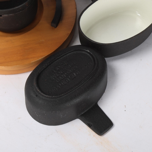 490 - Digsmed Design, Denmark, a cast iron fondue set with white enamel interior and beech wood base, make... 