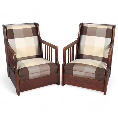 518 - Manner of CARL WESTMAN (1866-1936), a pair oak Arts and Crafts lounge chairs, the straight sides wit... 