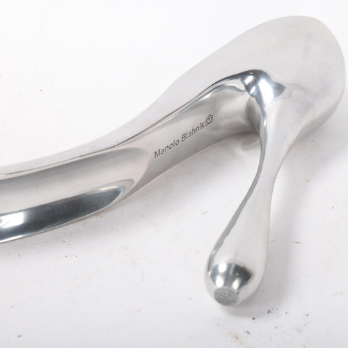 535 - MANOLO BLAHNIK, an aluminium stiletto shoe-horn / sculpture, makers marks to base, length 28cm