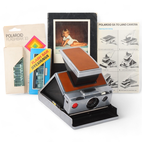 539 - A Polaroid SX-70 Land camera, with instruction pamphlet and 2 Flash Bars