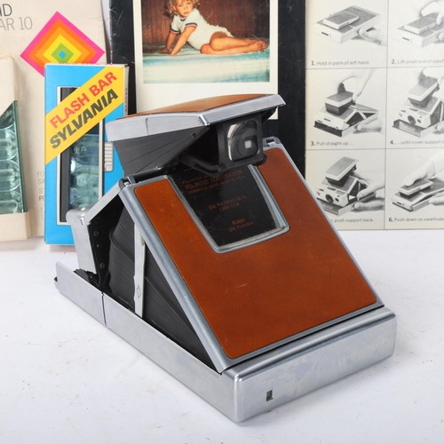 539 - A Polaroid SX-70 Land camera, with instruction pamphlet and 2 Flash Bars